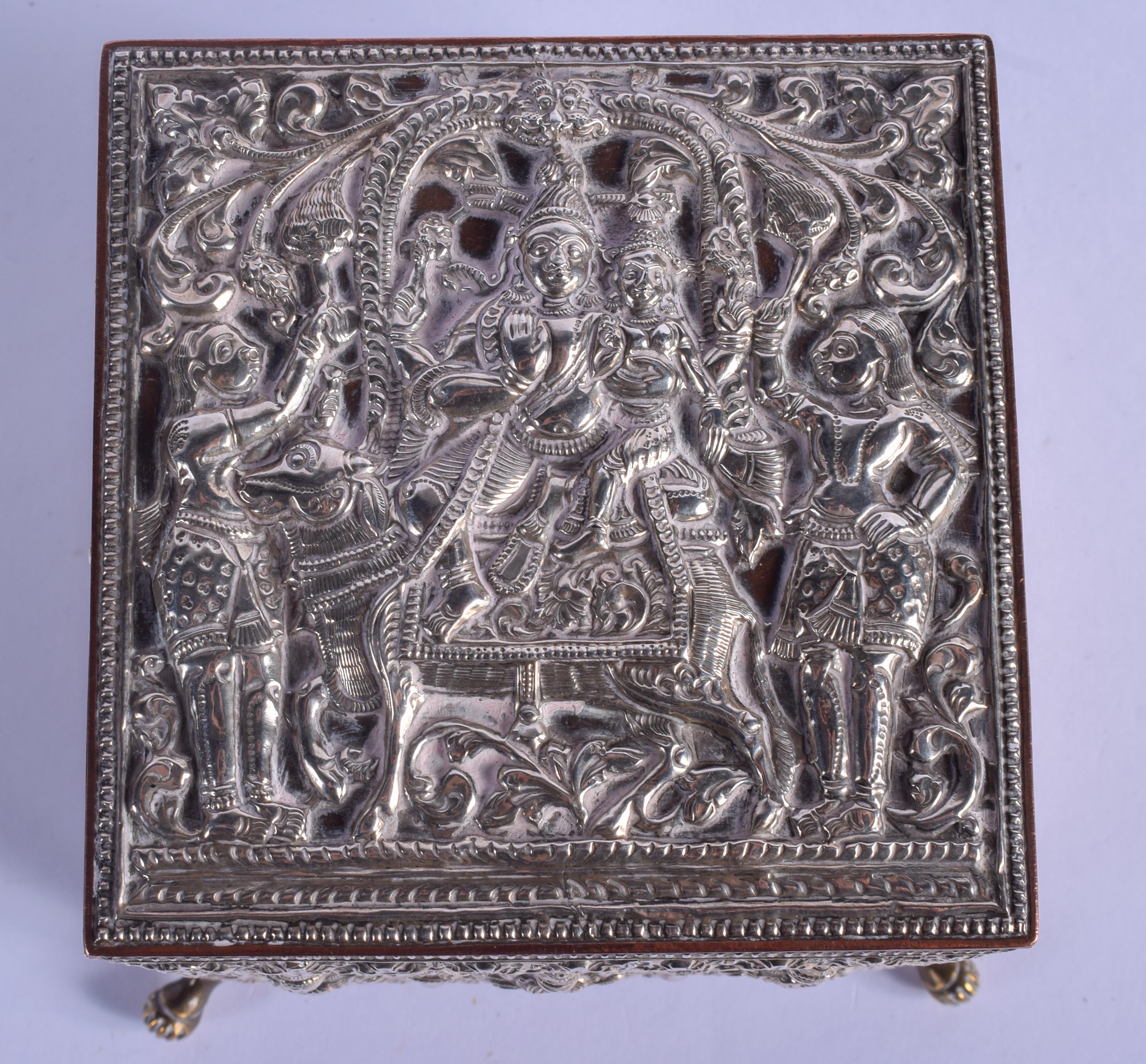 A 19TH CENTURY INDIAN SILVER OVERLAID CASKET decorated with Buddhistic figures. 12 cm x 9 cm. - Image 2 of 5