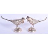 A PAIR OF STERLING SILVER FIGURES OF INDIAN BIRDS. 476 grams. 22 cm x 12 cm.