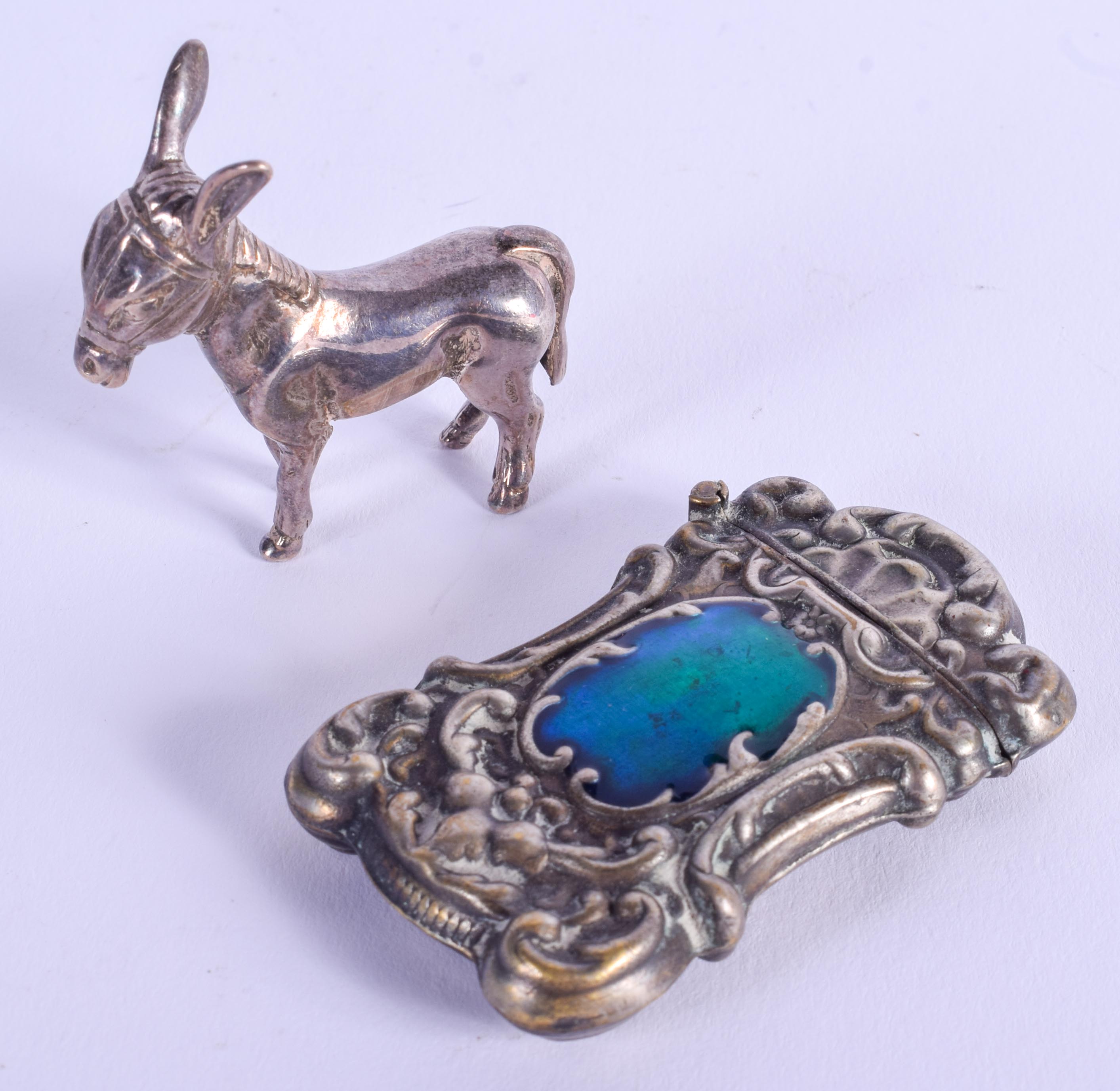 AN ENGLISH SILVER DONKEY together with an enamelled vesta. (2)