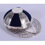 A SILVER JOCKEY HAT PIN CUSHION. 5 cm x 3.5 cm.