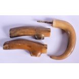 THREE 19TH CENTURY CARVED CONTINENTAL CARVED RHINOCEROS HORN HANDLES. Largest 11 cm wide. (3)