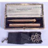 A VINTAGE GOLD FILLED PEN and a silver pendant. (2)