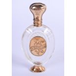 AN ANTIQUE 18CT GOLD MOUNTED CRYSTAL GLASS SCENT BOTTLE. 9 cm high.
