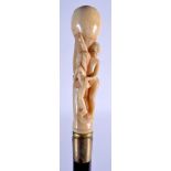 A NOVELTY BONE HANDLED CARVED WOOD WALKING CANE. 84 cm long.