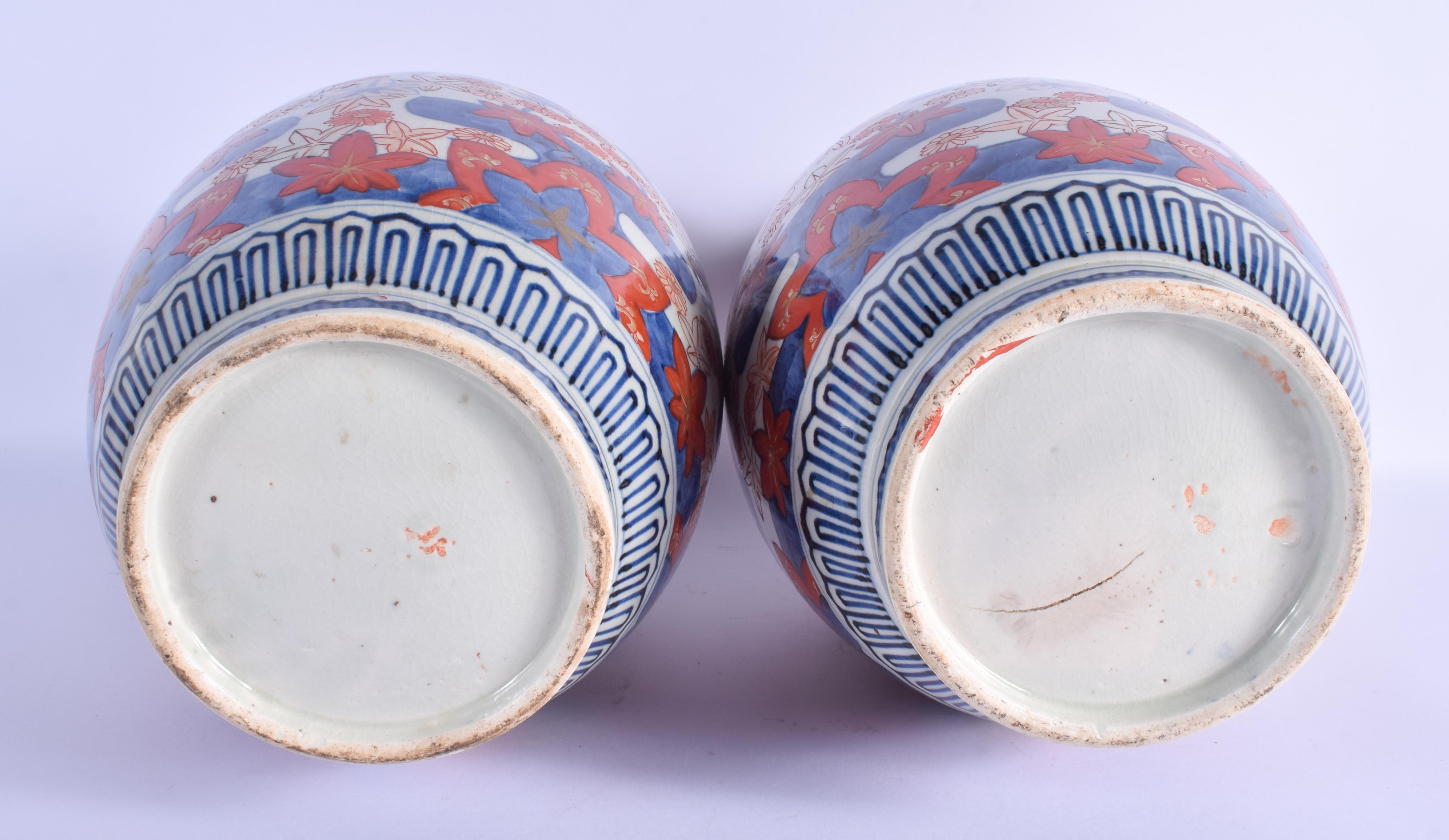 A LARGE PAIR OF 19TH CENTURY JAPANESE MEIJI PERIOD IMARI VASES painted with flowers. 37 cm x 15 cm. - Image 3 of 3