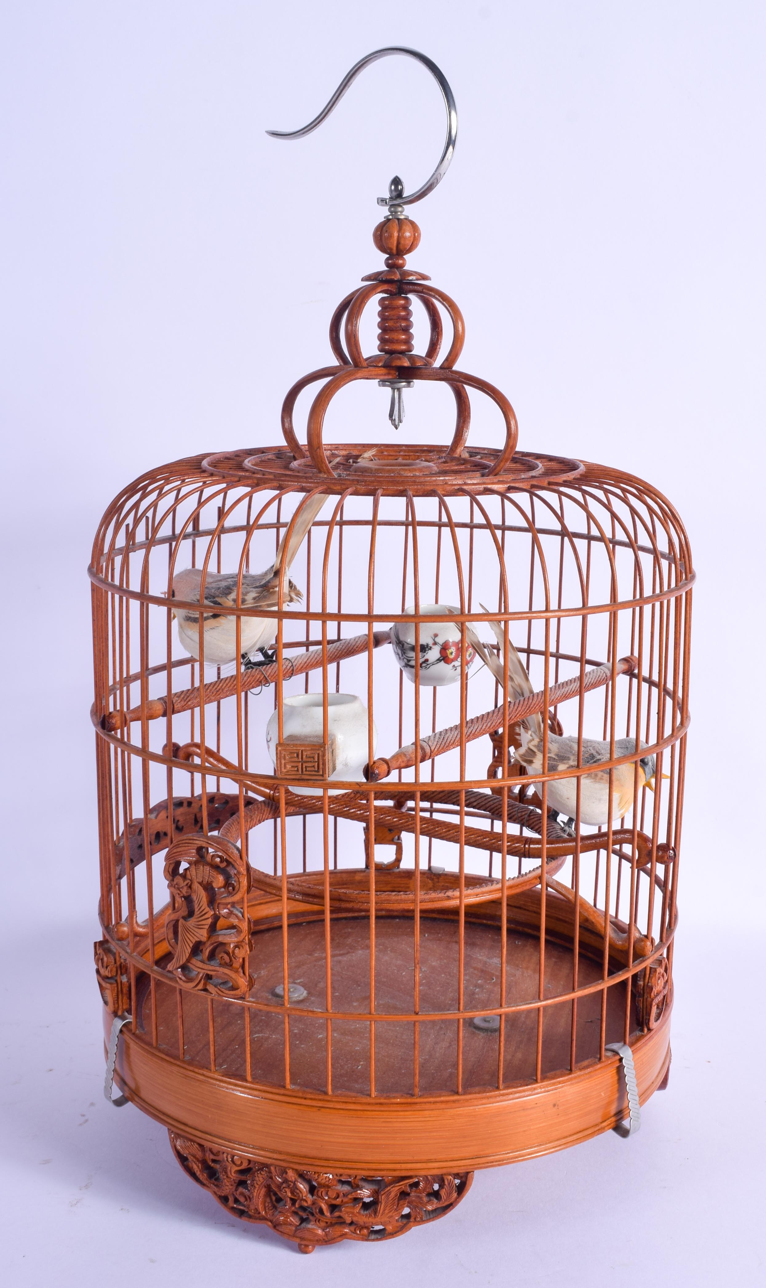 A CHINESE REPUBLICAN PERIOD BAMBOO BIRD CAGE with porcelain feeders. 35 cm x 18 cm. - Image 2 of 4