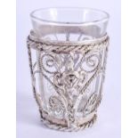 A SMALL VINTAGE WHITE METAL CASED SHOT GLASS. 7 cm high.