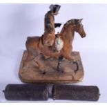 AN ANTIQUE CAST IRON PAINTED HORSE together with a pair of clock weights. Largest 30 cm x 25 cm. (3)