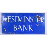 A BLUE ENAMEL WESTMINSTER BANK SIGN. 50 cm x 24 cm.