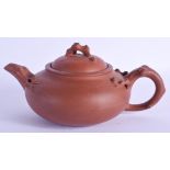 AN EARLY 20TH CENTURY CHINESE YIXING POTTERY TEAPOT AND COVER Late Qing. 18 cm wide.