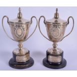 A PAIR OF ART DECO SILVER TROPHIES. Silver 299 grams. Silver 11.5 cm high.