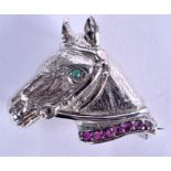 A SILVER AND RUBY BROOCH. 3.25 cm wide.
