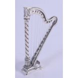 A SILVER HARP. 6 cm x 3.25 cm.