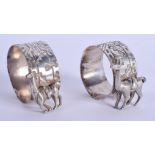 A PAIR OF ART DECO WHITE METAL CAMEL NAPKIN RINGS. 4 cm x 3 cm.