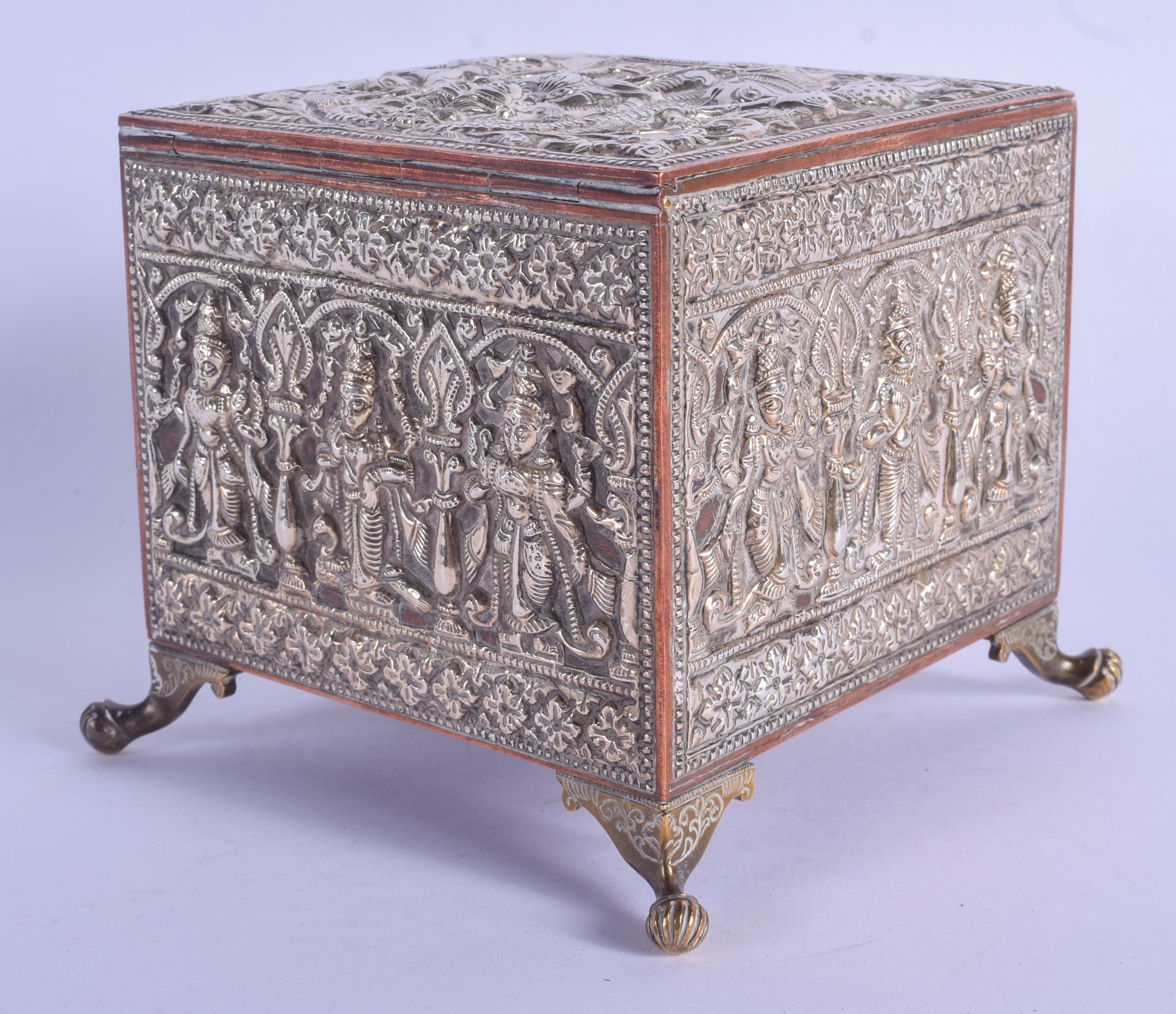 A 19TH CENTURY INDIAN SILVER OVERLAID CASKET decorated with Buddhistic figures. 12 cm x 9 cm.