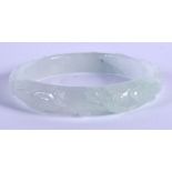 A CHINESE CARVED PALE JADEITE BANGLE 20th Century. 6 cm diameter.