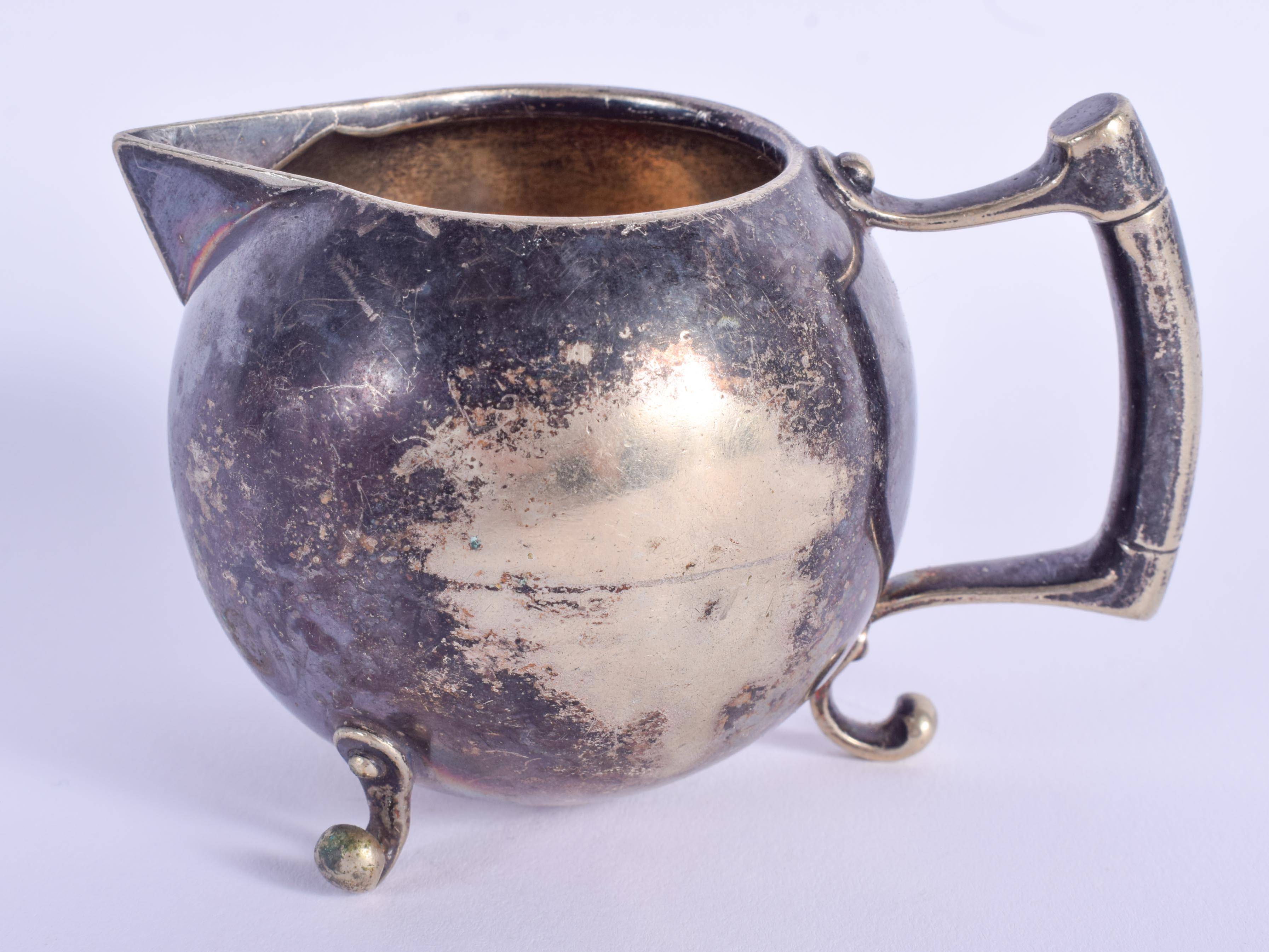 AN ARTS AND CRAFTS CHRISTOPHER DRESSER SILVER PLATED CREAM JUG. 109 grams. 8 cm wide.