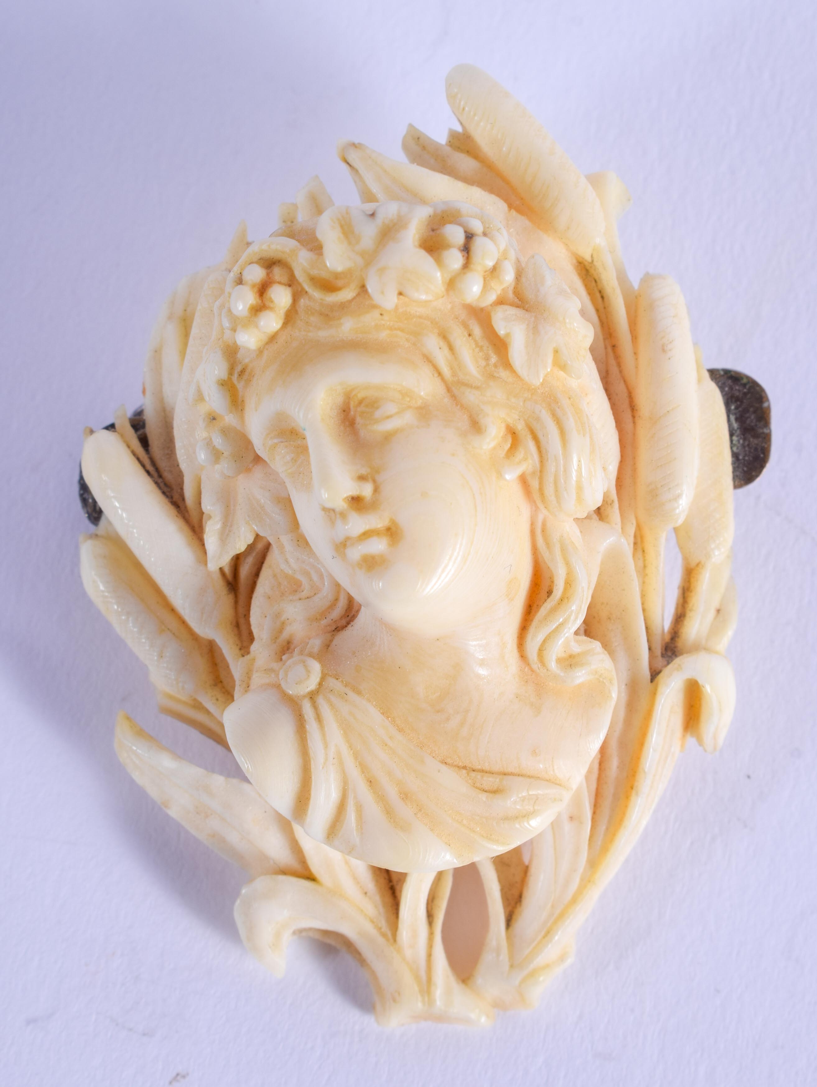 A FINE 19TH CENTURY EUROPEAN CARVED IVORY BROOCH formed as a classical maiden. 4 cm x 5.5 cm.