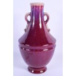 AN EARLY 20TH CENTURY CHINESE TWIN HANDLED FLAMBE VASE Late Qing, with drip glazed decoration. 24 cm