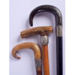 TWO 19TH CENTURY CONTINENTAL CARVED RHINOCEROS HORN WALKING CANES together with another similar. Lar