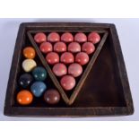 A SET OF BILLIARD BALLS within a case. (qty)