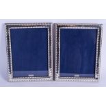 A PAIR OF SILVER PHOTOGRAPH FRAMES. 23 cm x 17 cm.