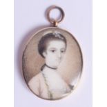 AN 18TH/19TH CENTURY GOLD MOUNTED BONE PORTRAIT MINIATURE. 2.75 cm x 3.5 cm.