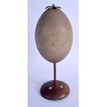 AN ARTS AND CRAFTS COPPER AND TURQUOISE OSTRICH EGG. 24 cm high.