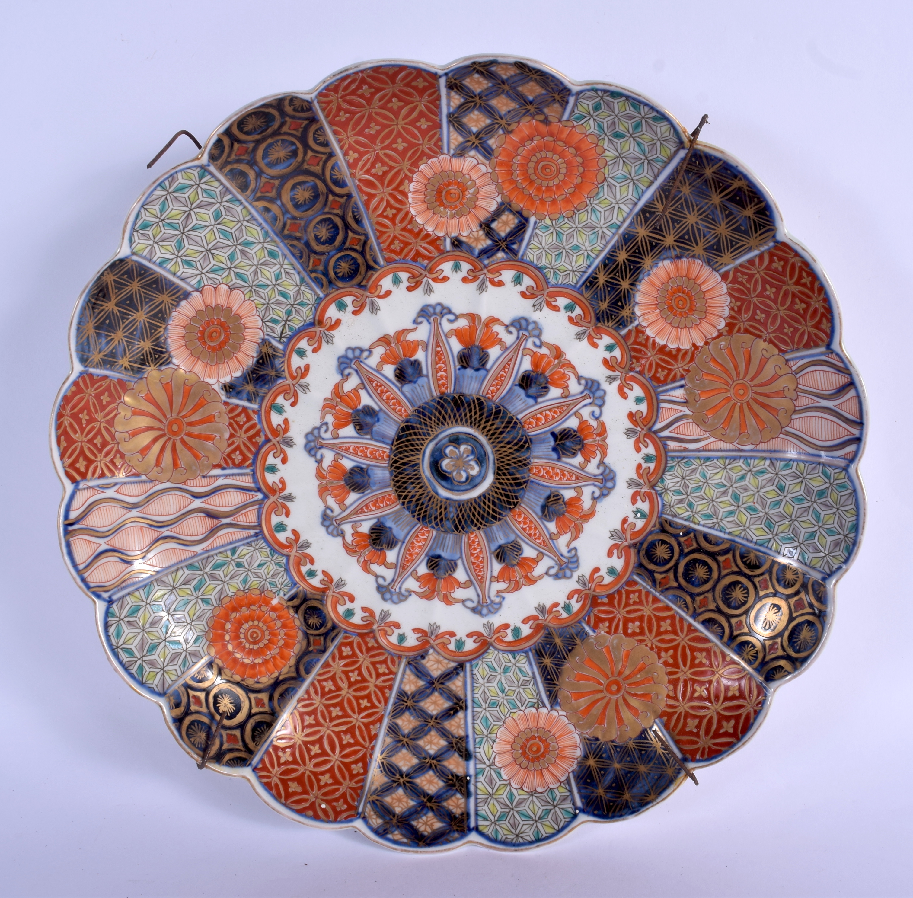 A 19TH CENTURY JAPANESE MEIJI PERIOD SCALLOPED DISH painted with flowers and motifs. 30 cm diameter.