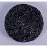 A CHINESE CARVED BLACK JADE PENDANT. 4.25 cm wide.