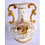 Coalport two handled vase painted with a landscape of a lake and abbey ruins on a moulded and raised