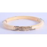A 19TH CENTURY JAPANESE MEIJI PERIOD CARVED IVORY MONKEY BANGLE with yellow metal mounts. 10 cm wide