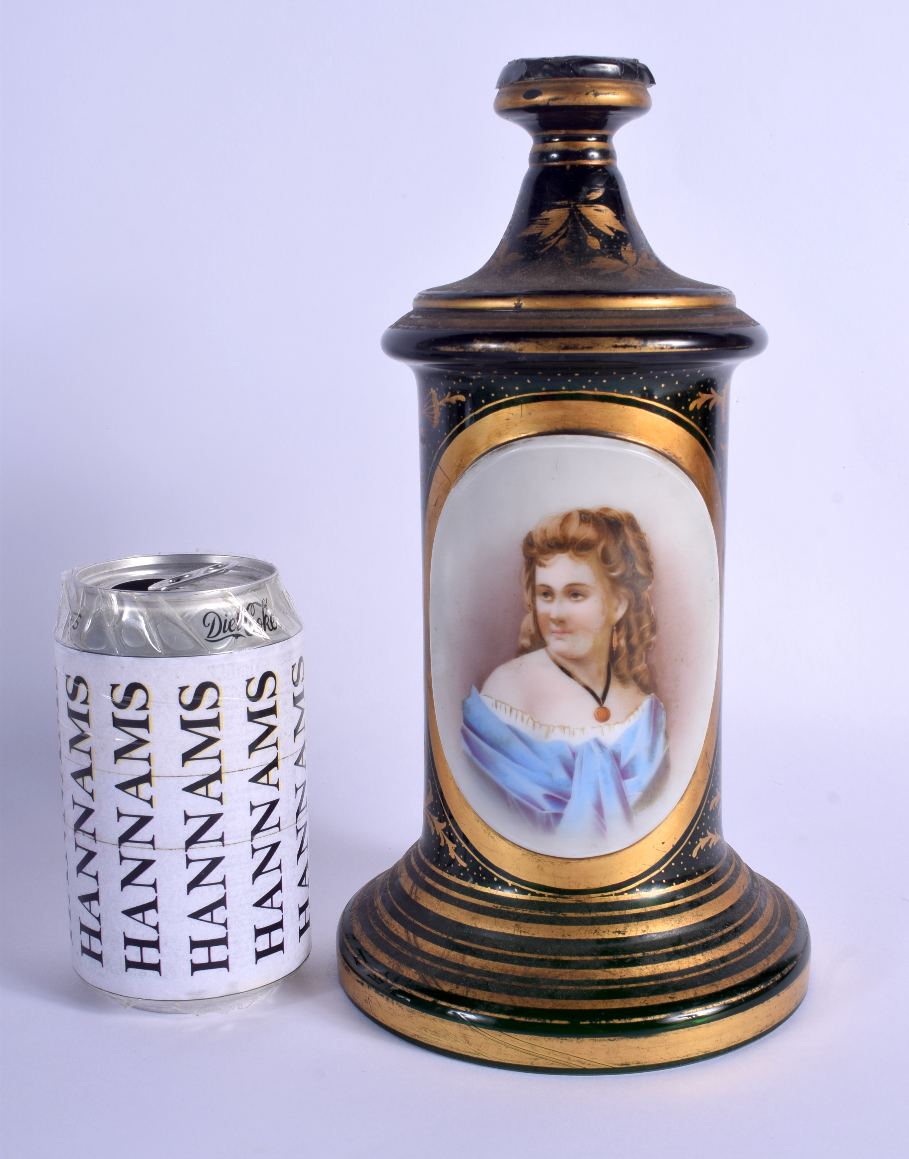 A 19TH CENTURY BOHEMIAN GREEN GLASS PEDESTAL painted with a female in blue. 26 cm high.