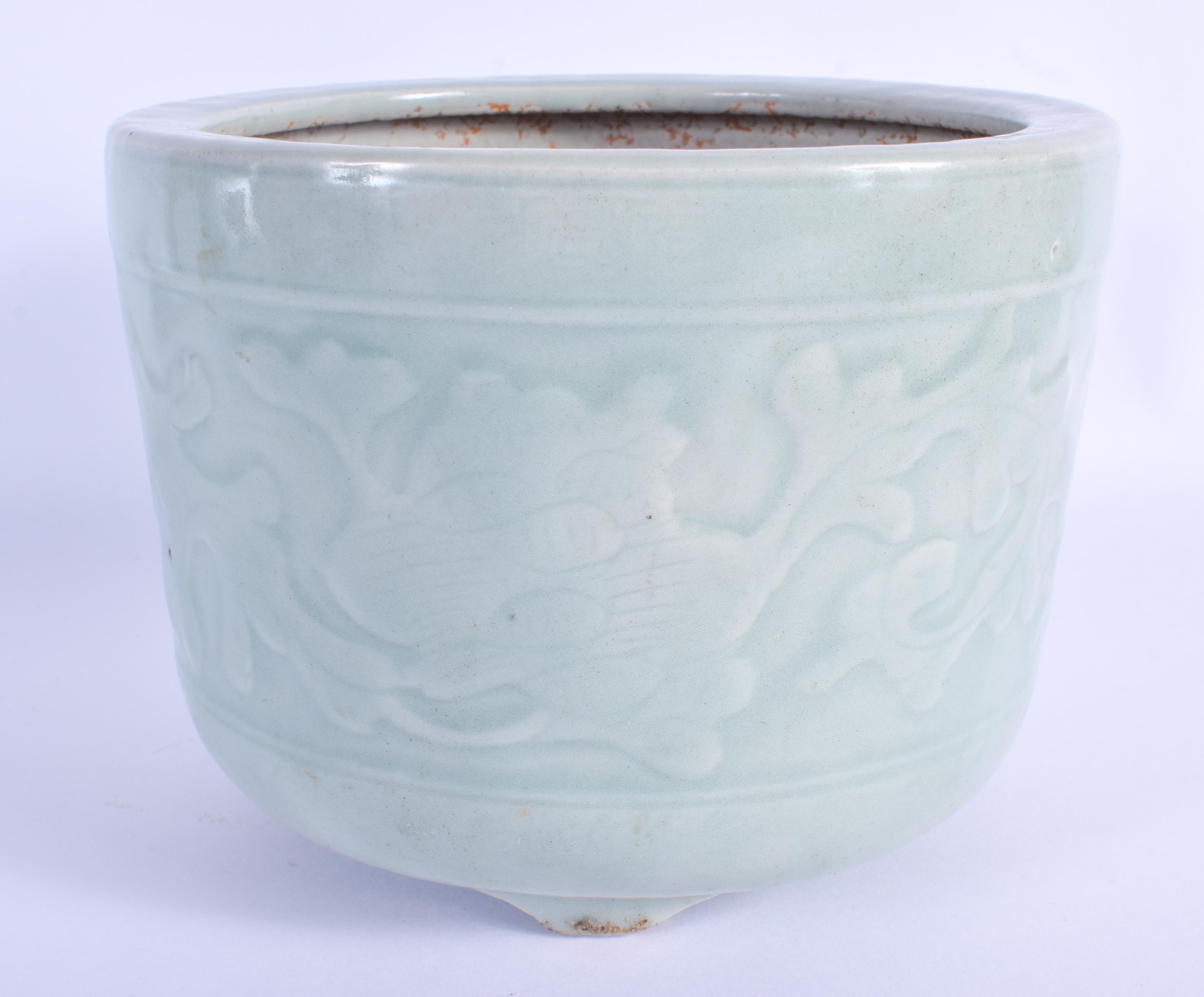 A 19TH CENTURY CHINESE CELADON PORCELAIN JARDINIERE Qing, decorated with foliage. 18 cm x 13 cm.