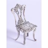 A VINTAGE MINIATURE SILVER CHAIR. 13 grams. 5 cm x 2 cm.