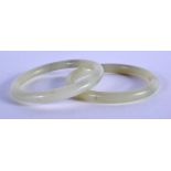 A PAIR OF 19TH CENTURY CHINESE JADE BANGLES Late Qing. 7.25 cm diameter.