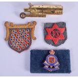 AN EMBROIDERED BADGE and a lighter. (2)