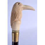 A NOVELTY BONE HANDLED CARVED WOOD WALKING CANE. 84 cm long.