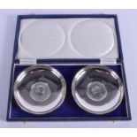 A PAIR OF SILVER SIERRA LEONE SILVER COIN DISHES. London 1975. 193 grams. 11 cm diameter.