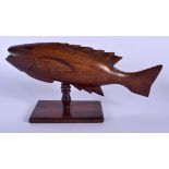 A PITCAIRN ISLANDS CARVED WOOD FIGURE OF A FLYING FISH of unusually good colour. 30 cm x 8 cm.