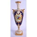 Royal Worcester vase with two headed handles painted with fruit in a highly gilded panel on a cobalt