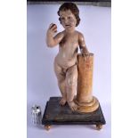 A LARGE 17TH/18TH CENTURY EUROPEAN POLYCHROMED WOOD FIGURE OF A PUTTI modelled holding a fruit. 69 c