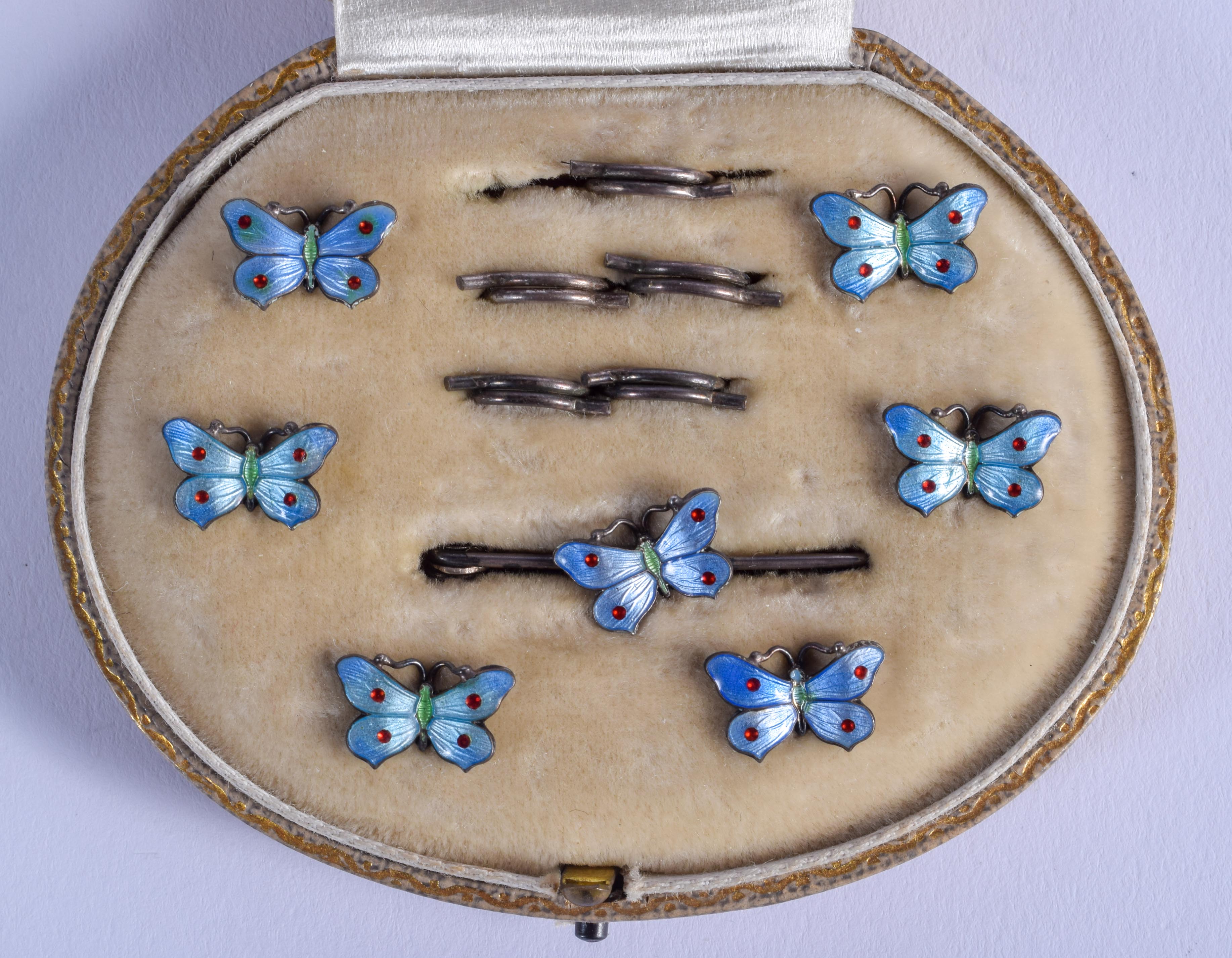 A CHARMING ART DECO SILVER AND ENAMEL BUTTERFLY BUTTON SET. 1 cm x 0.5 cm.