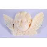 A 19TH CENTURY EUROPEAN CARVED IVORY CHERUB BROOCH. 4 cm x 2.5 cm.