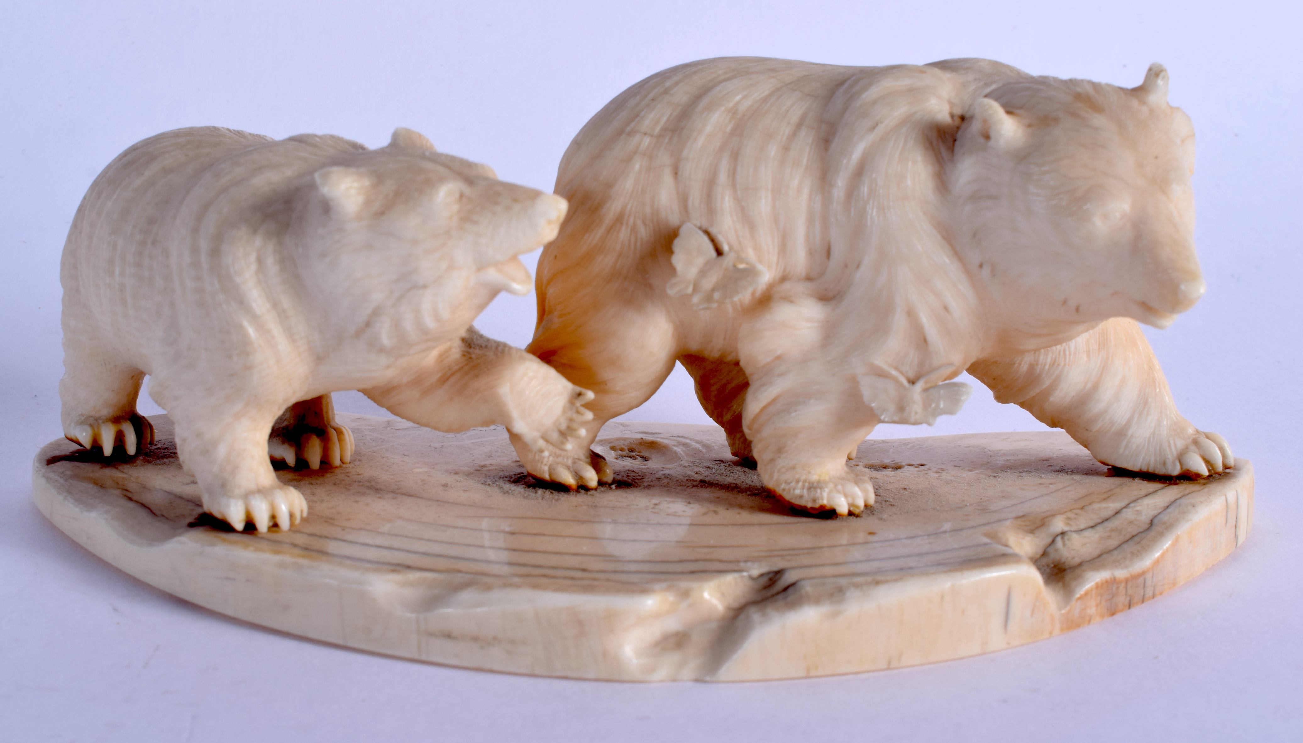 A 19TH CENTURY JAPANESE MEIJI PERIOD CARVED IVORY OKIMONO modelled as roaming bears. 14 cm x 6 cm.