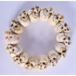 AN EARLY 20TH CENTURY JAPANESE MEIJI PERIOD CARVED BONE SKULL BRACELET. 8 cm wide.