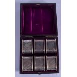 A CASED SET OF AESTHETIC MOVEMENT SILVER NAPKIN RINGS. Sheffield 1880. 118 grams. 4 cm wide. (6)