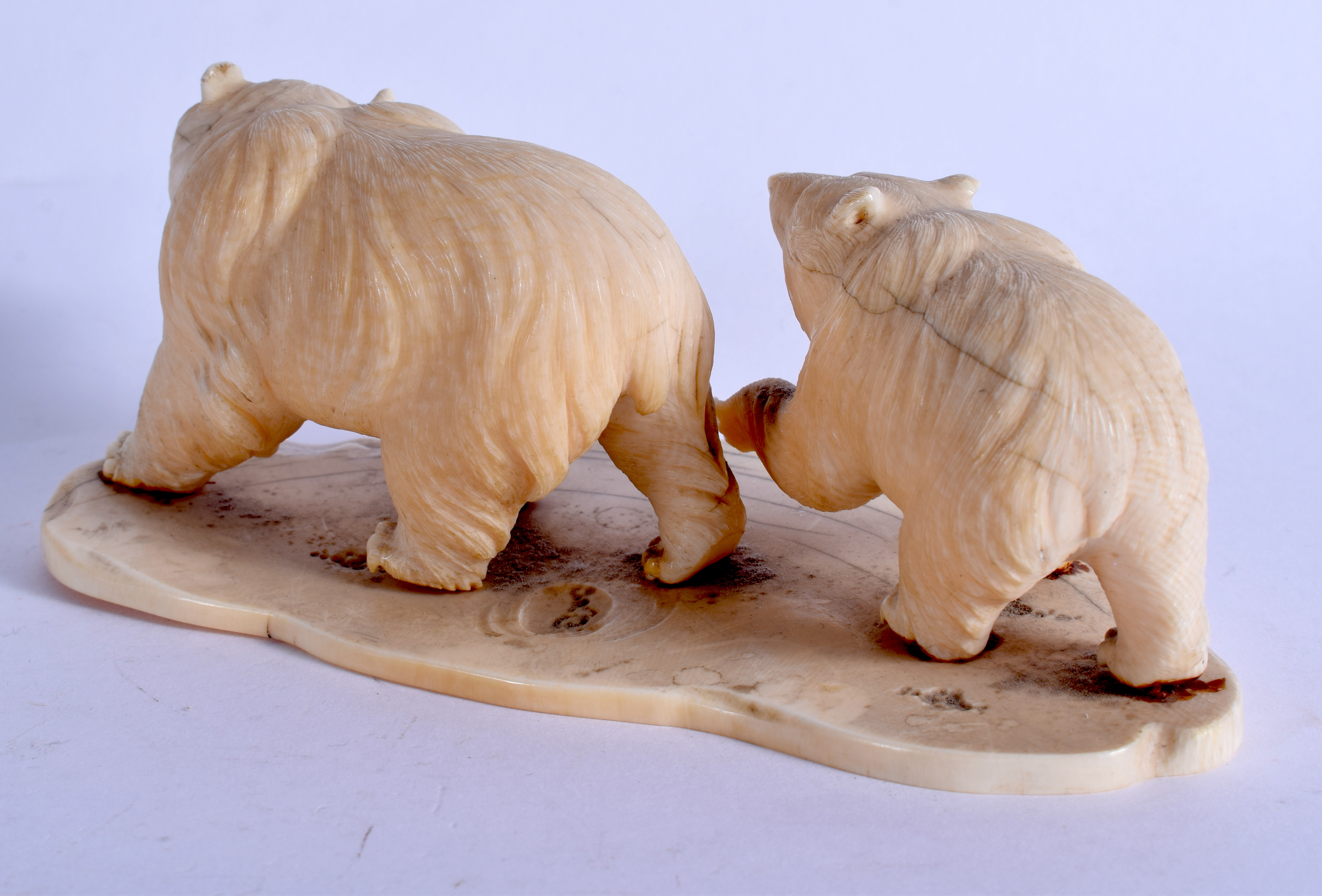 A 19TH CENTURY JAPANESE MEIJI PERIOD CARVED IVORY OKIMONO modelled as roaming bears. 14 cm x 6 cm. - Image 3 of 4