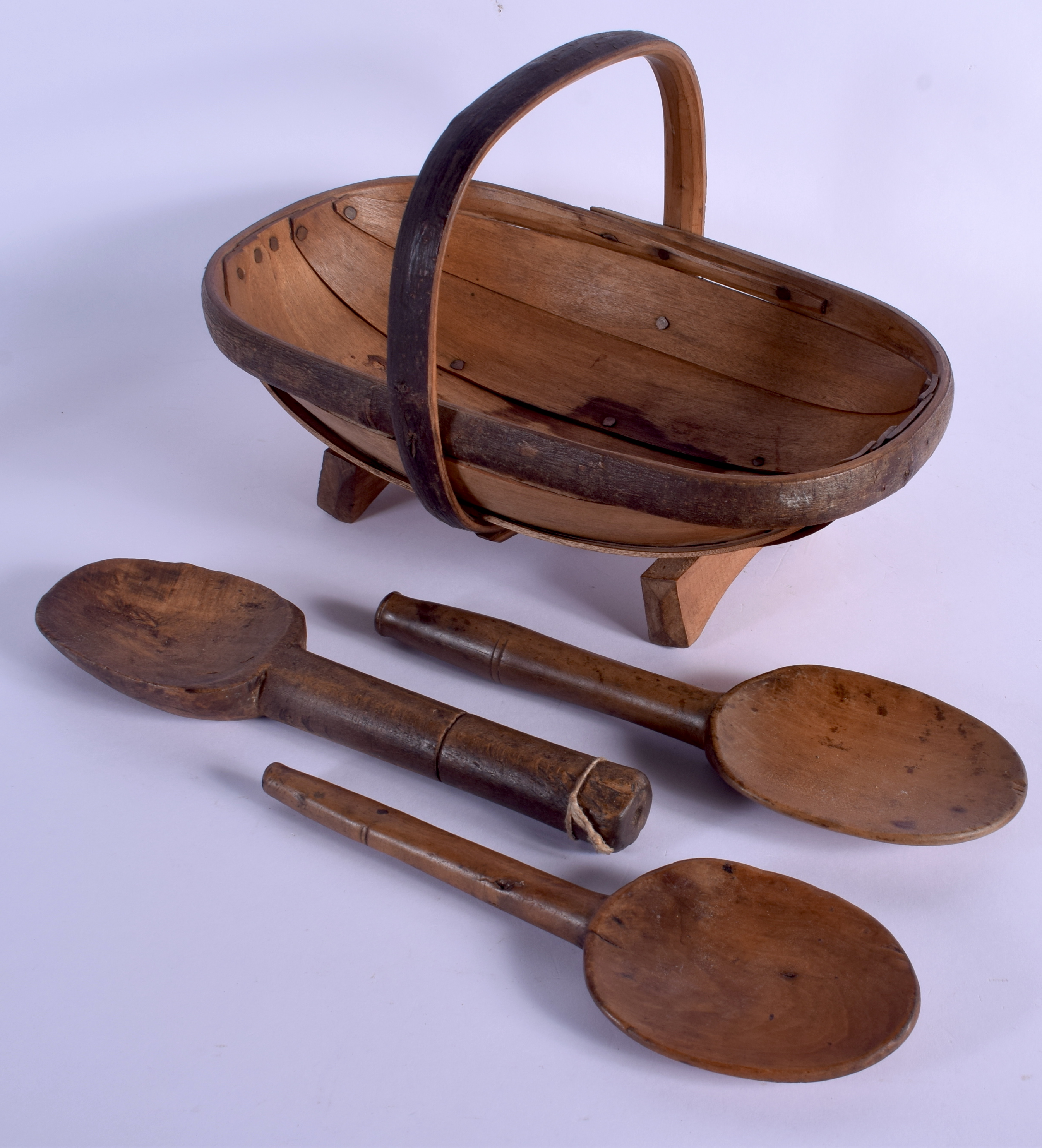 THREE FRUITWOOD DAIRY SPOONS and a basket. Largest 28 cm x 20 cm. (4)