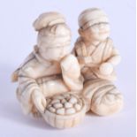 A 19TH CENTURY JAPANESE MEIJI PERIOD CARVED IVORY NETSUKE modelled as two opposing figures. 4 cm x 4